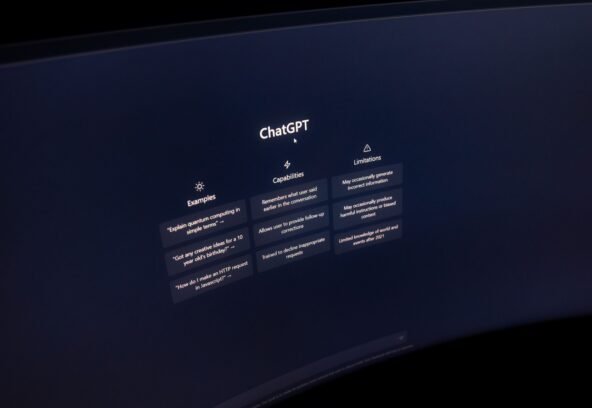 Close-up of a computer screen displaying ChatGPT interface in a dark setting.