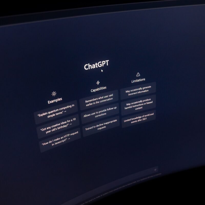 Close-up of a computer screen displaying ChatGPT interface in a dark setting.