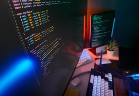pexels-34212916 A vibrant workspace featuring colorful code on computer monitors, ideal for developers.