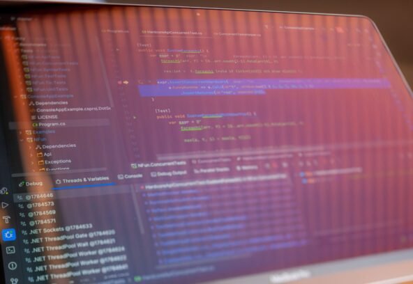 pexels-34803998 Focused view of a computer screen displaying programming code with visible reflections.