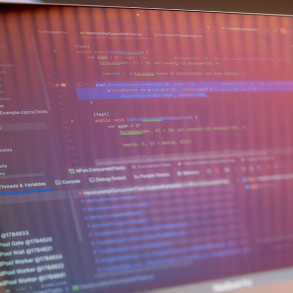 Focused view of a computer screen displaying programming code with visible reflections.