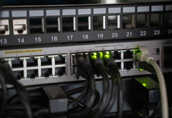 Networking equipment with connected cables, showcasing modern technology infrastructure.