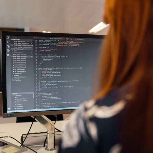 A female engineer works on code in a contemporary office setting, showcasing software development.